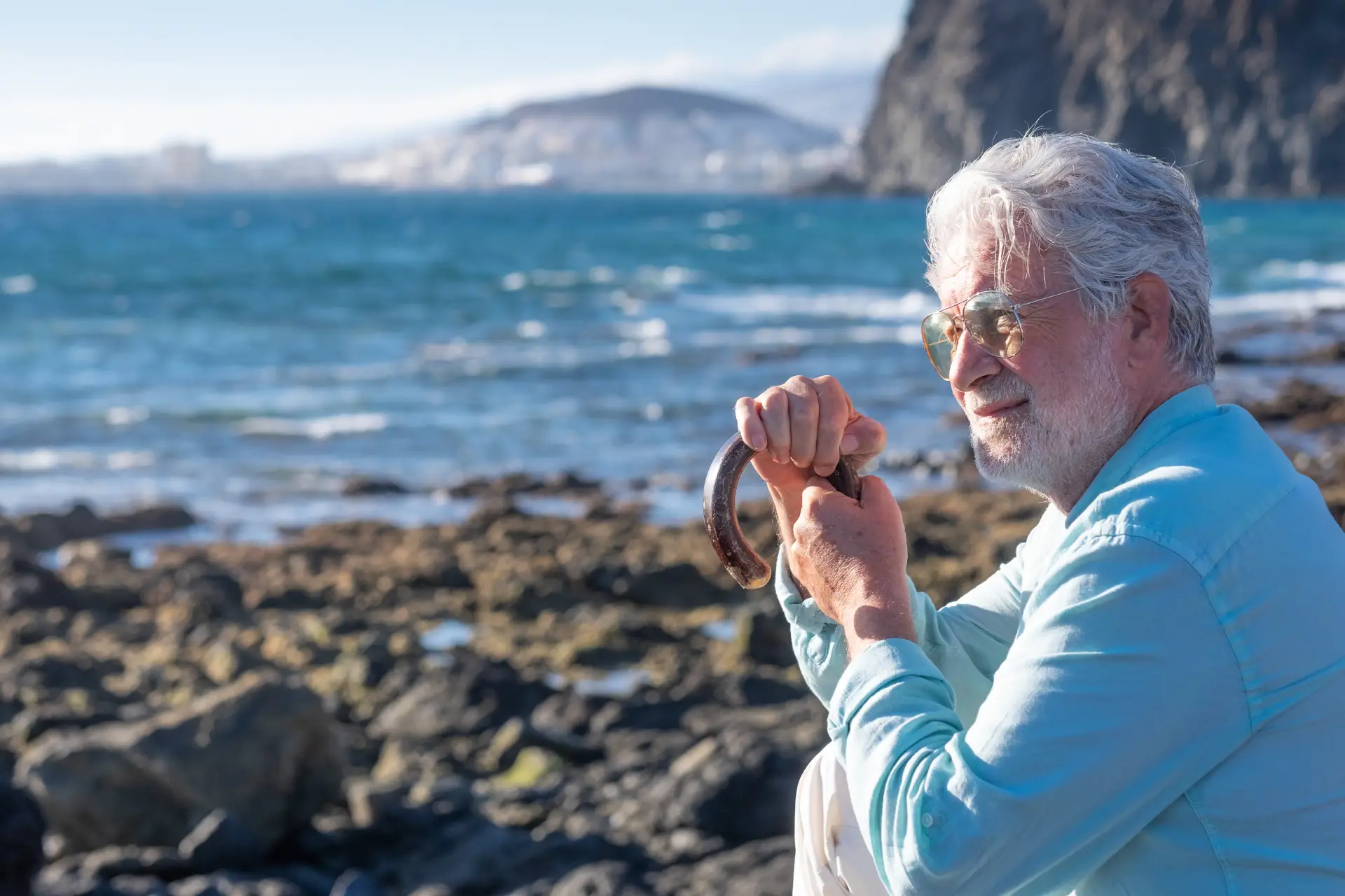 senior man white haired holding a walking cane